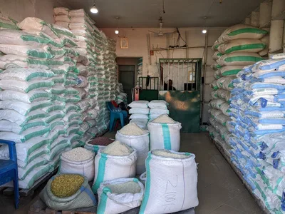Inside a sales centre: open sacks of rice, maize and beans